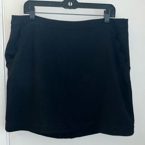 Black mini skirt with scallop hem
